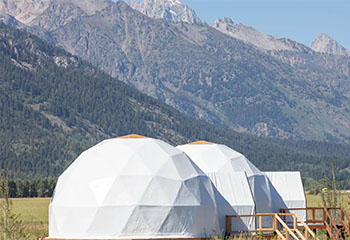 Image of white geodesic domes, Teton County from https://cowboystatedaily.com/2024/05/07/judge-says-its-troubling-state-can-flaunt-teton-county-regs-to-ok-glamping/