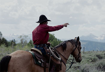 Rancher Jake Hutton points towards the edge of the Kelly Parcel where it meets Grand Teton National Park on June 21. (Reed Mattison)